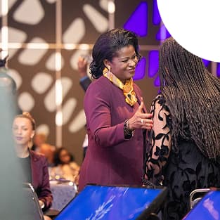 Two participants greet each other and chat at the 2025 NBCS Gala